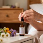 Femme caucasienne utilisant des fleurs de Bach comme aide au sommeil sur une table de nuit, éclairage naturel doux